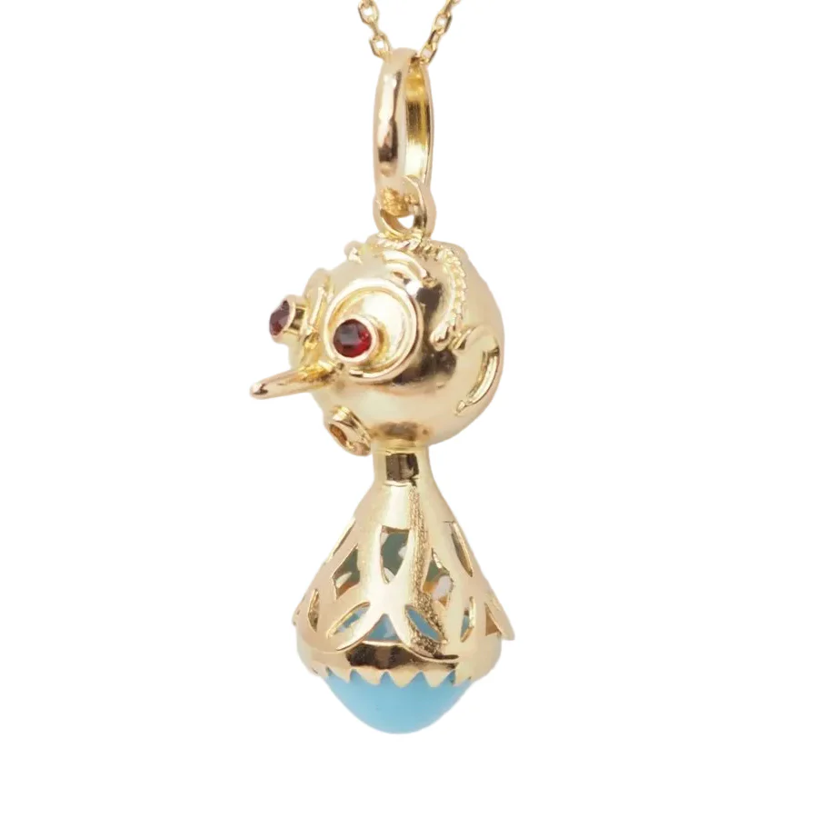 Pendentif en or jaune, turquoise et grenats
